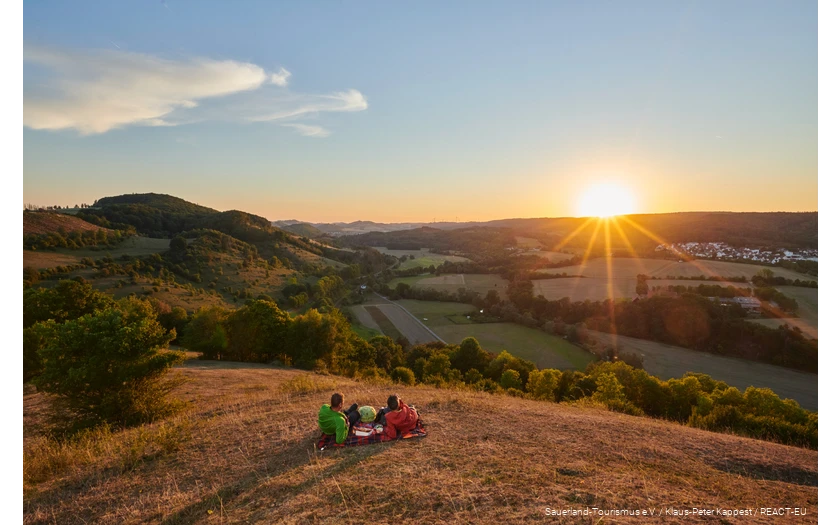 A couple enjoys the sunset with a view of Marsberg.