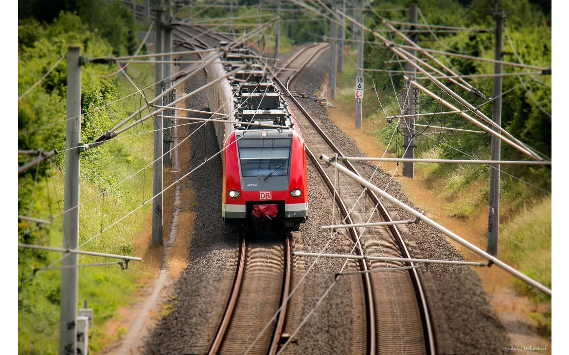 A Deutsche Bahn train travels through the countryside.