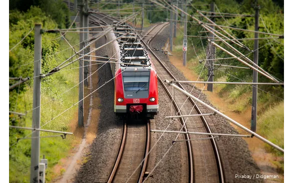 A Deutsche Bahn train travels through the countryside.