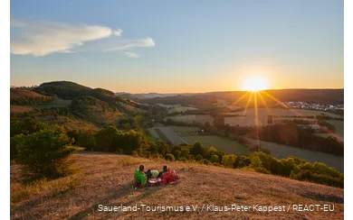A couple enjoys the sunset with a view of Marsberg.