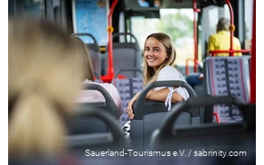 A woman is sitting on the bus.