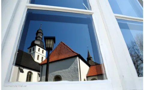 Reflectie van de kerktoren in het raam