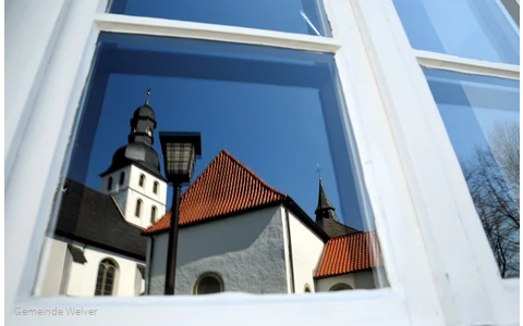 Reflection of the church tower in the window