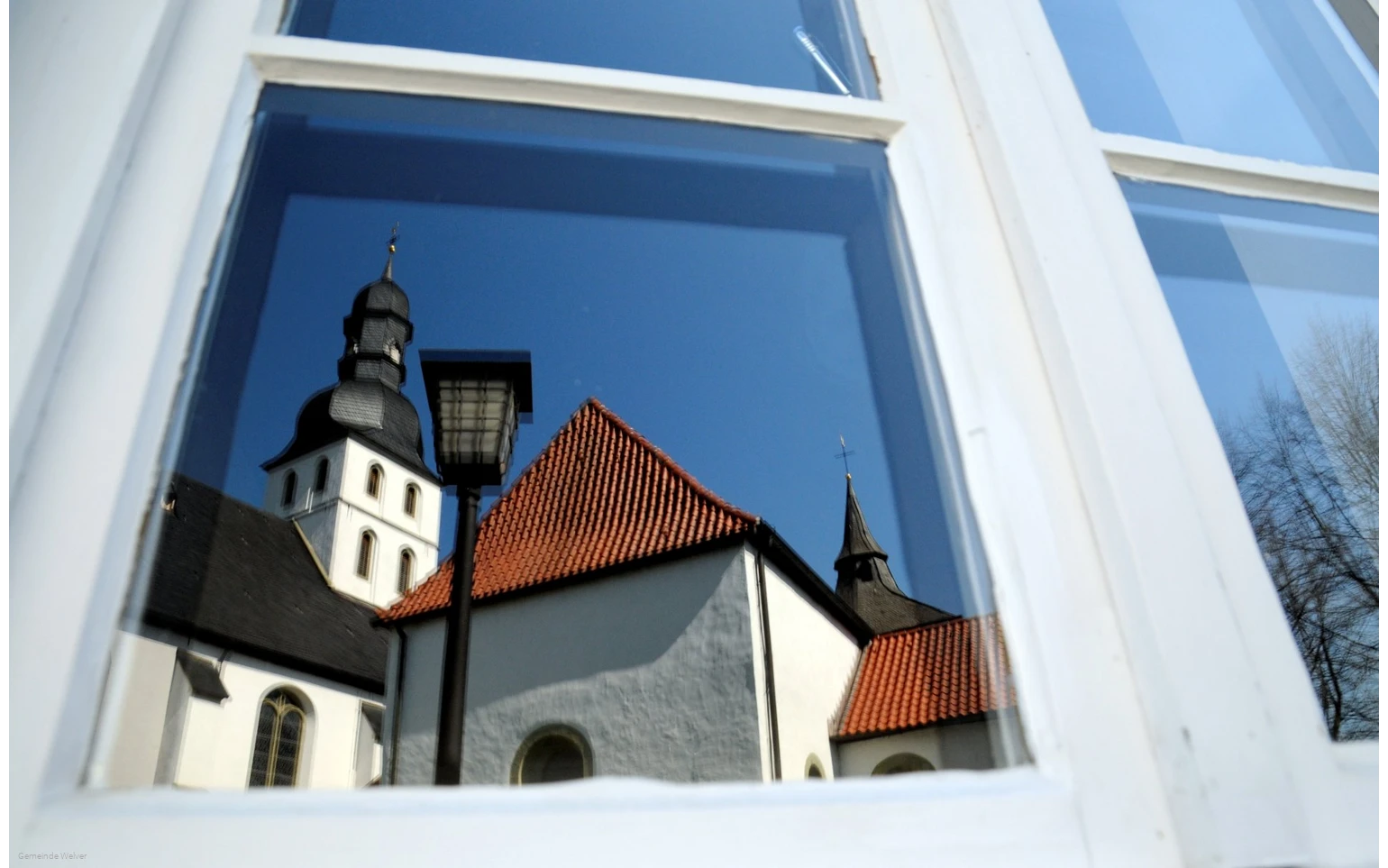 Reflection of the church tower in the window
