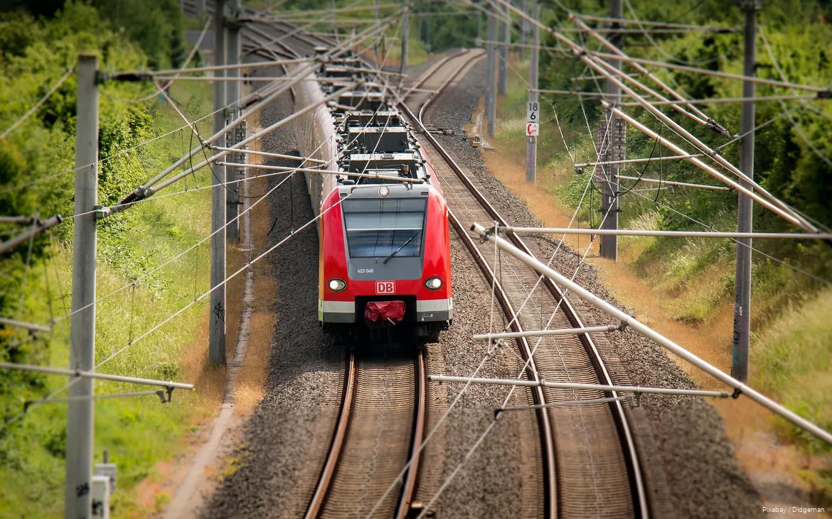 A Deutsche Bahn train travels through the countryside.