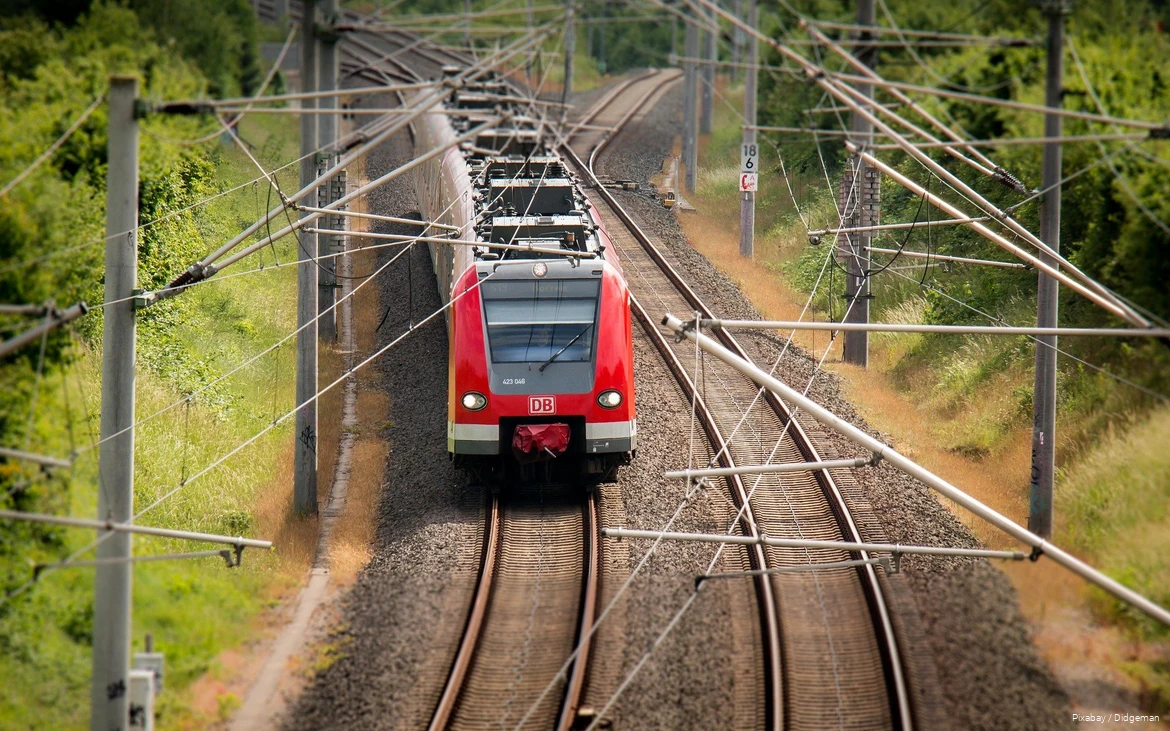 A Deutsche Bahn train travels through the countryside.