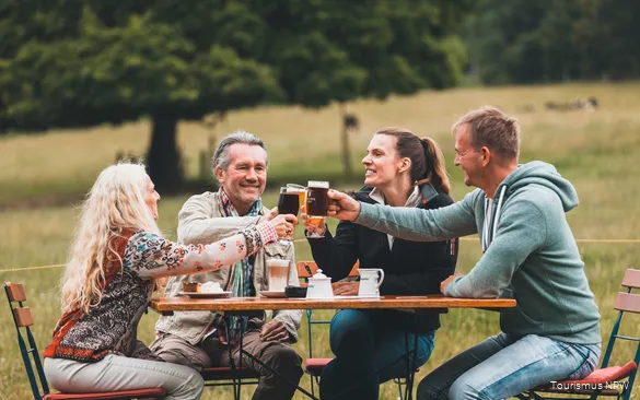 A group toasts with drinks.