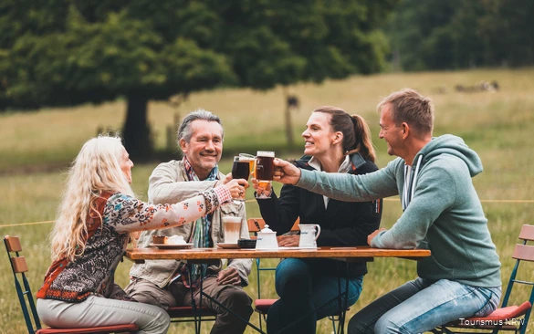 A group toasts with drinks.