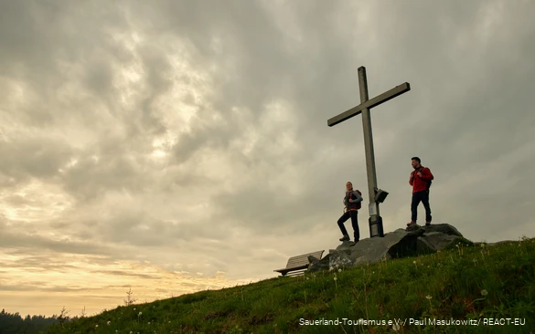 Two hikers enjoy the sunset on the Clemensberg.