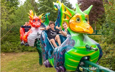 Smiling children on the dragon train in Panorama Park