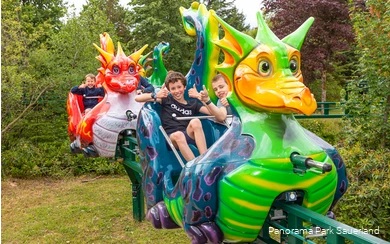 Smiling children on the dragon train in Panorama Park