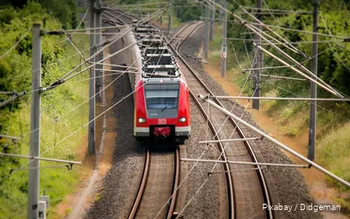 A Deutsche Bahn train travels through the countryside.