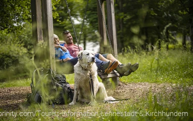 Urlauber mit Hund machen während einer Wanderung eine Pause. Sie wandern mit dem Hund auf den Wanderwegen im Sauerland