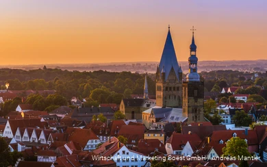 Aerial view of Soest with church in the center and orange sunset sky