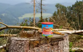 A can of mead on a tree stump.