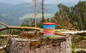 A can of mead on a tree stump.
