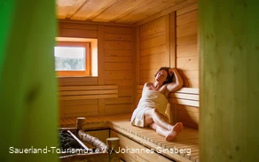 A woman relaxes in the sauna.
