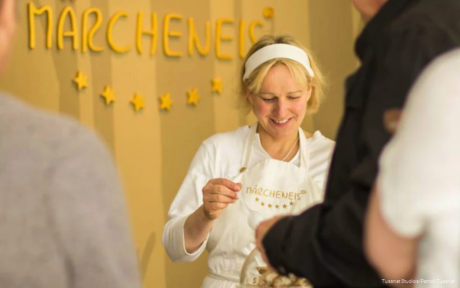 A woman prepares ice cream.