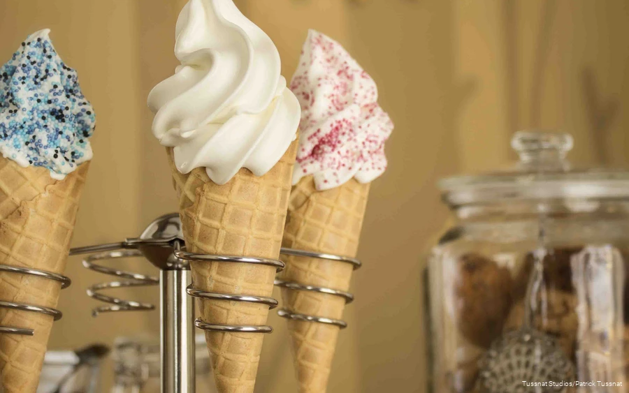 Three ice cream cones in a stand.