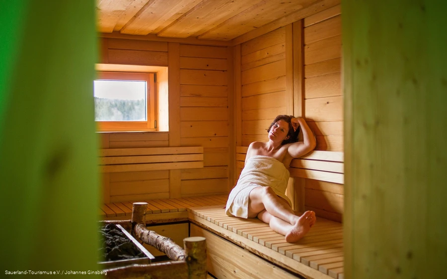 Time out in the sauna A woman relaxes in the sauna.