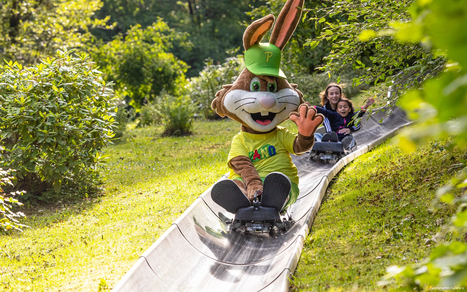 The Panorama Park mascot Pano rides the Fichtenflitzer summer toboggan run.