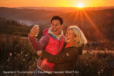 Two happy hikers taking a selfie