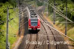 A Deutsche Bahn train travels through the countryside.