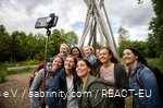 A group of women stand in front of the Kyrill-Tor in Brilon and pose for a selfie.