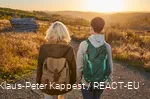Two female hikers on the Sauerland-Waldroute at sunset.