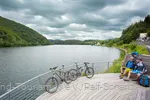 Two mountain bikers take a break on the riverbank