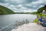 Two mountain bikers take a break on the riverbank