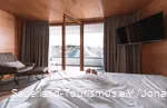 Only the feet look out of a bed with an open window