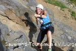Woman climbing on the rock.