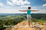 A woman enjoys the sweeping view from the Bruchhauser Steine
