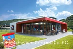 Exterior shot of the Metten factory outlet with a can of Dicken Sauerland Bockwurst in the foreground