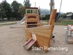 A play element in the shape of a ship on a playground.