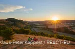 A couple enjoys the sunset with a view of Marsberg.