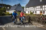 A couple goes on a bike tour through a half-timbered village.