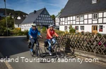 A couple goes on a bike tour through a half-timbered village.
