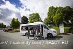 A group of friends get into the minibus.