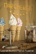 Three ice cream cones in a stand.
