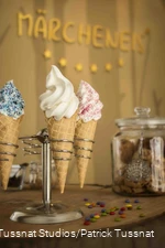 Three ice cream cones in a stand.