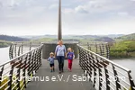 Mother with two children by the hand walking along the Skywalk Biggeblick.