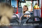 A woman is sitting on the bus.