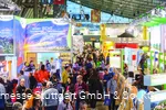 An exhibition hall full of information stands and people