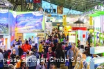 An exhibition hall full of information stands and people