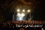 Concert in de Dechenhöhle met veel bezoekers die naar de muziek op het podium luisteren.